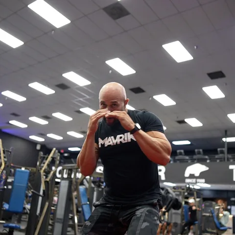 Boxer shadowboxing in a MAVRIK tee at the gym